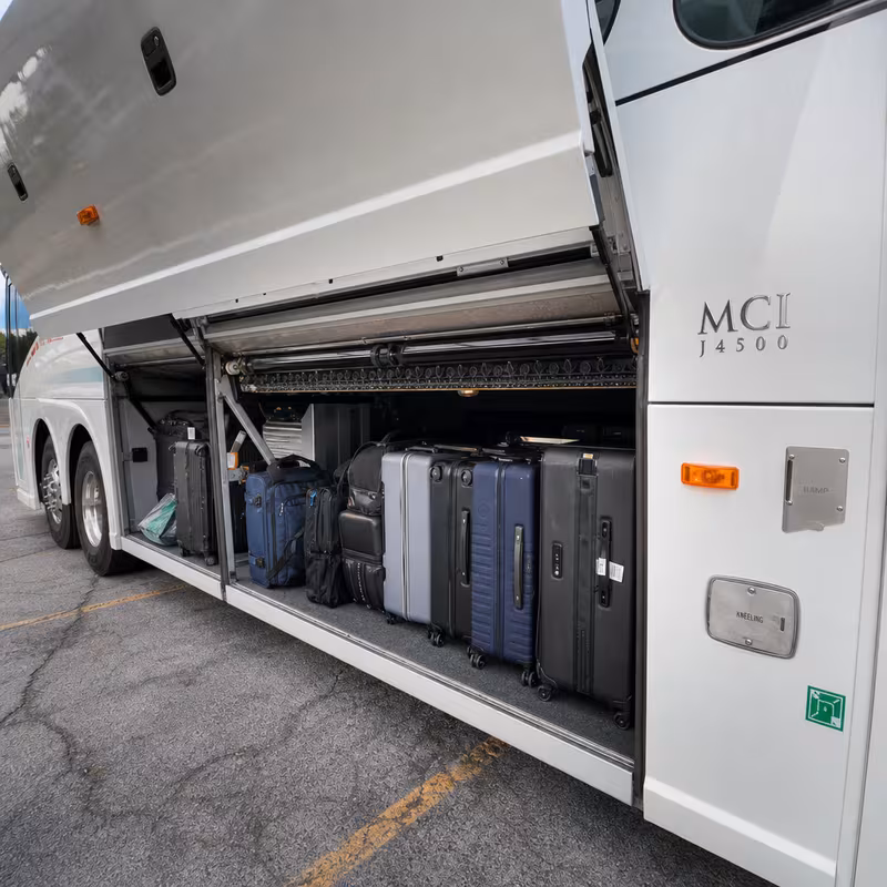 Party bus interior with wraparound leather seating and LED lighting in Arlington