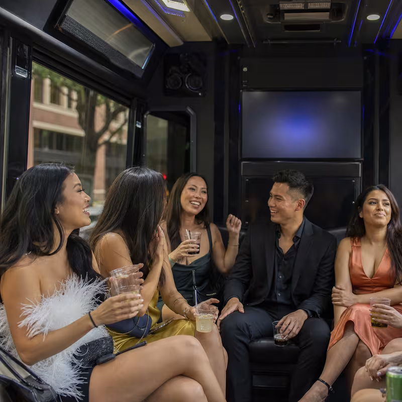 Party bus interior with wraparound leather seating and LED lighting in Arlington