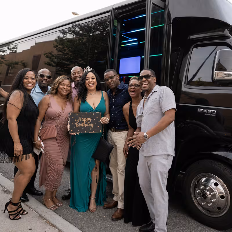 Group boarding a white charter bus for Birthday Transportation transportation in Arlington