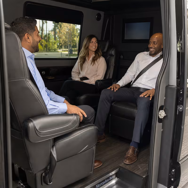 Group boarding a white charter bus for Corporate Transportation transportation in Arlington