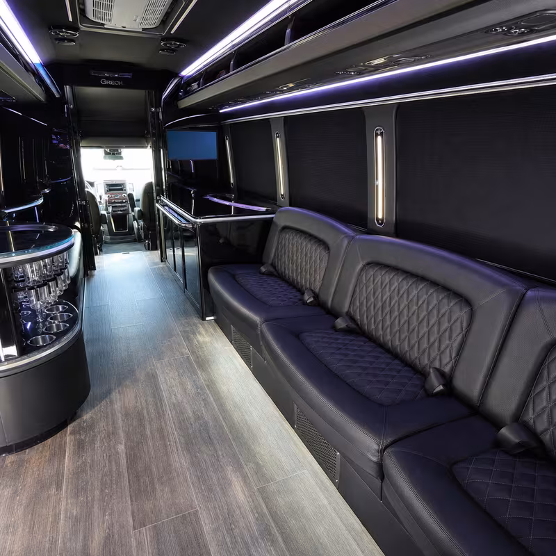 Party bus interior with wraparound leather seating and LED lighting in Arlington