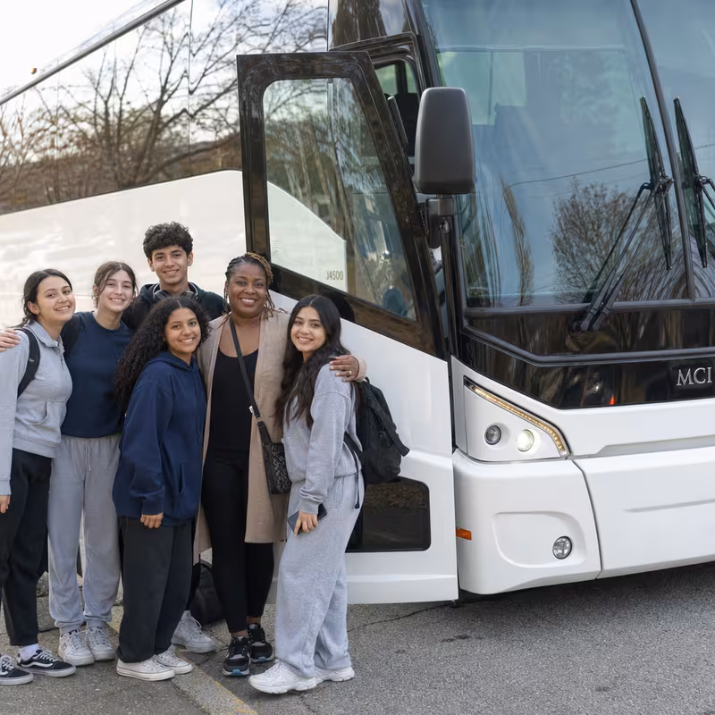 Passengers loading luggage while boarding an Arlington group shuttle