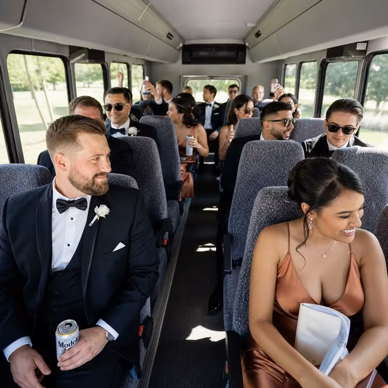 Group boarding a white charter bus for Wedding Transportation transportation in Arlington