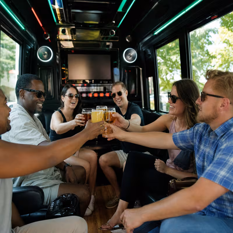 Group boarding a white charter bus for Winery & Brewery Tour Transportation transportation in Arlington