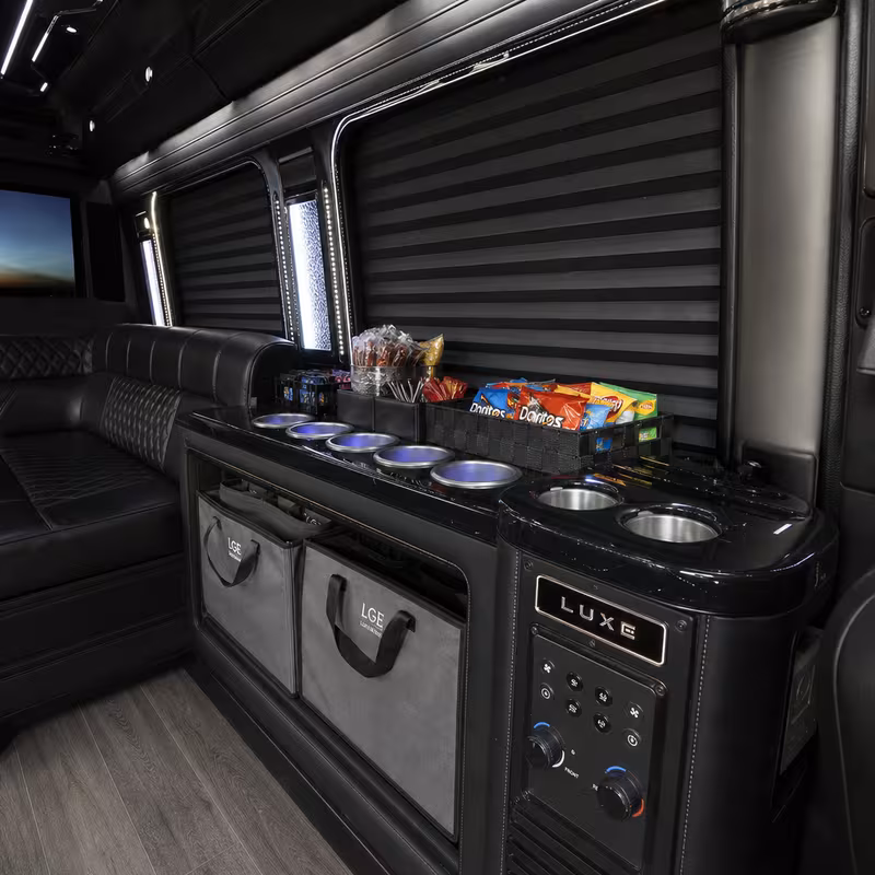 Party bus interior with wraparound leather seating and LED lighting in Arlington